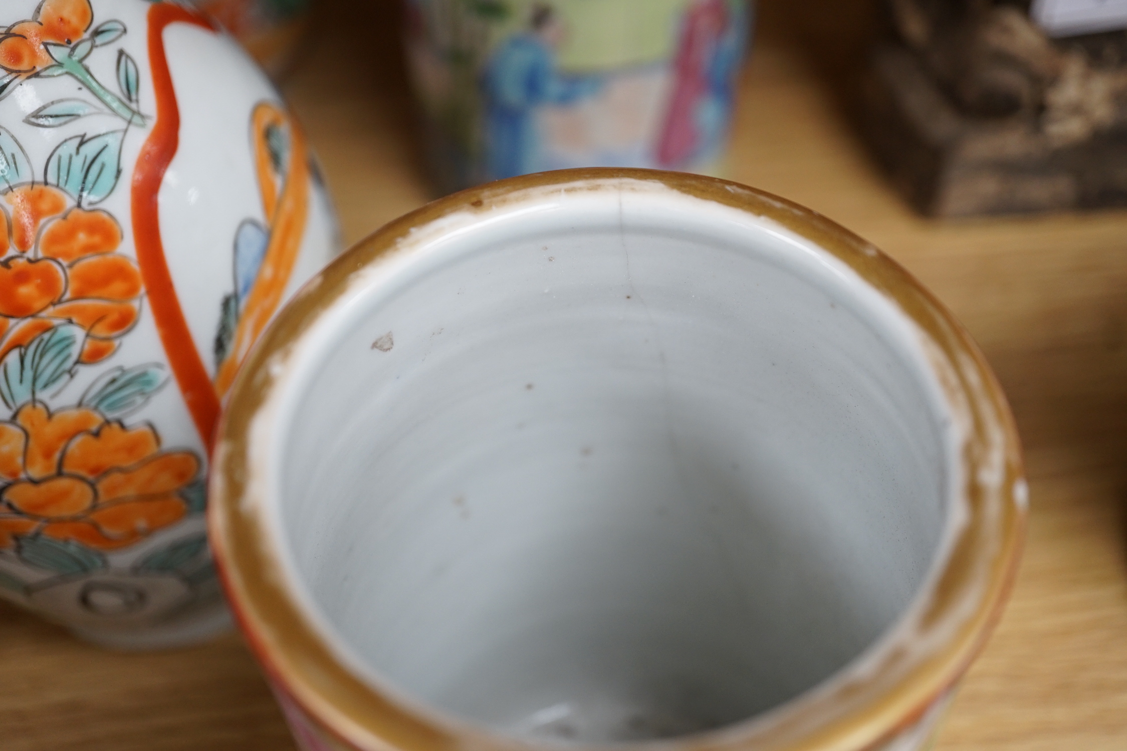A pair of 19th century Cantonese famille rose porcelain brushpots, decorated with figural scenes, together with a further pair of Japanese export vases (4)